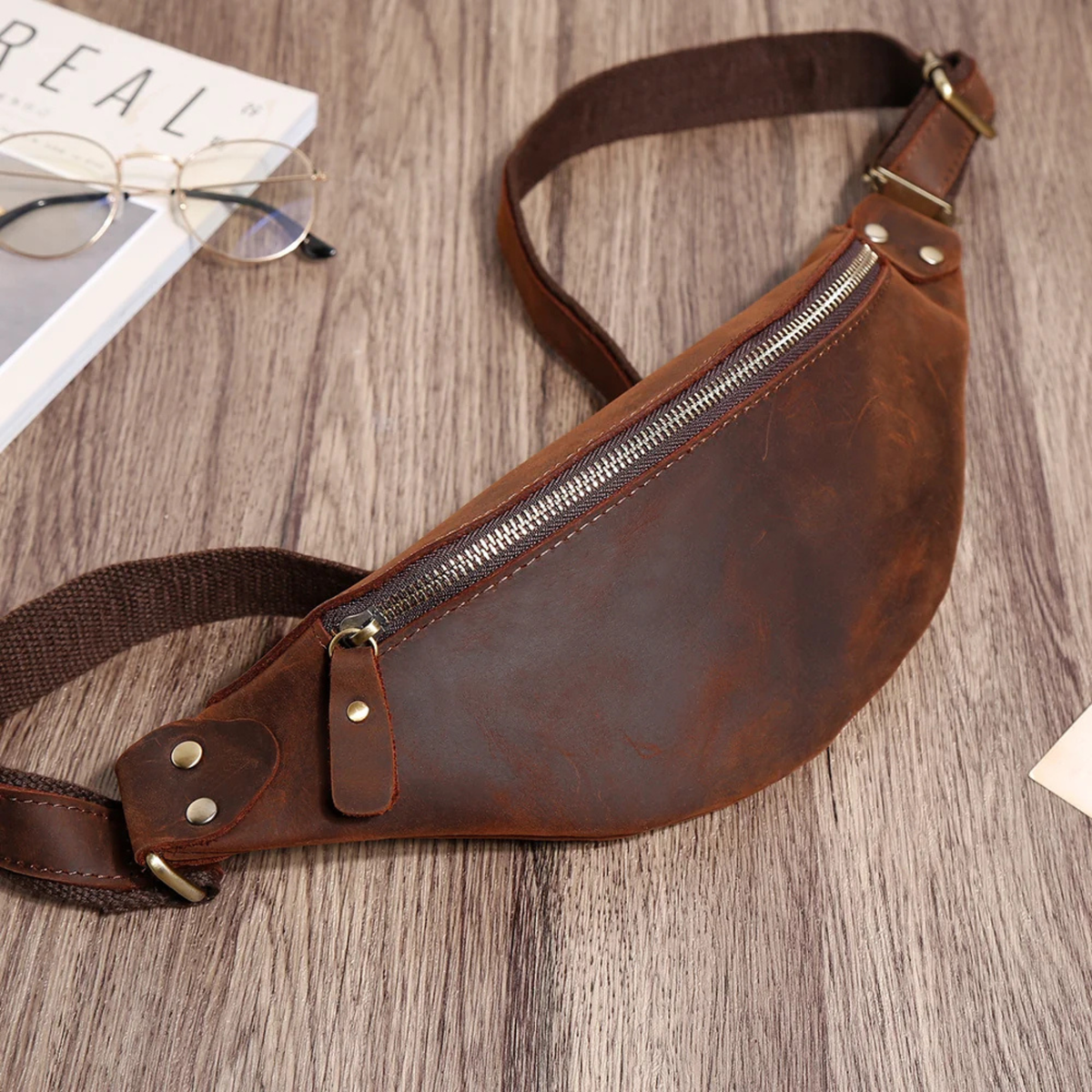 Dark brown leather waist bag side view with adjustable strap
