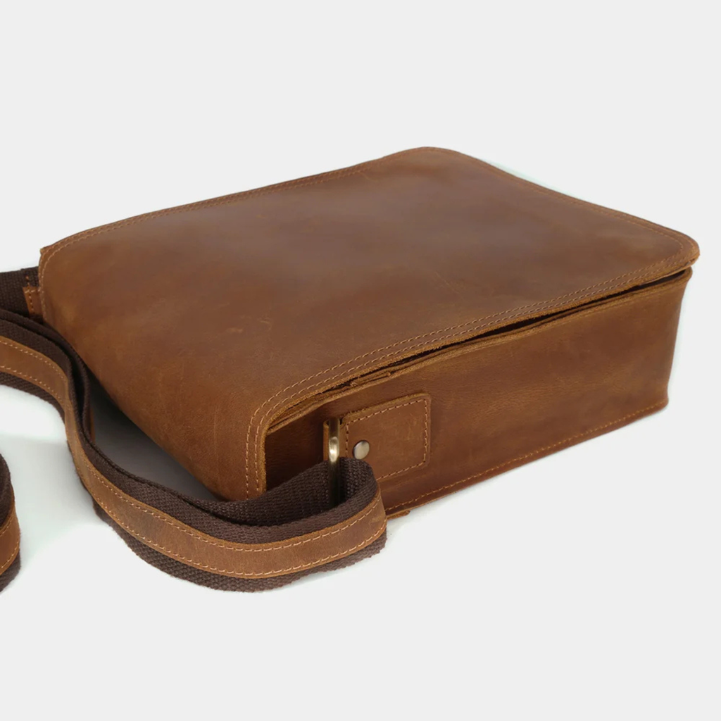 Brown leather shoulder bag bottom and strap detail