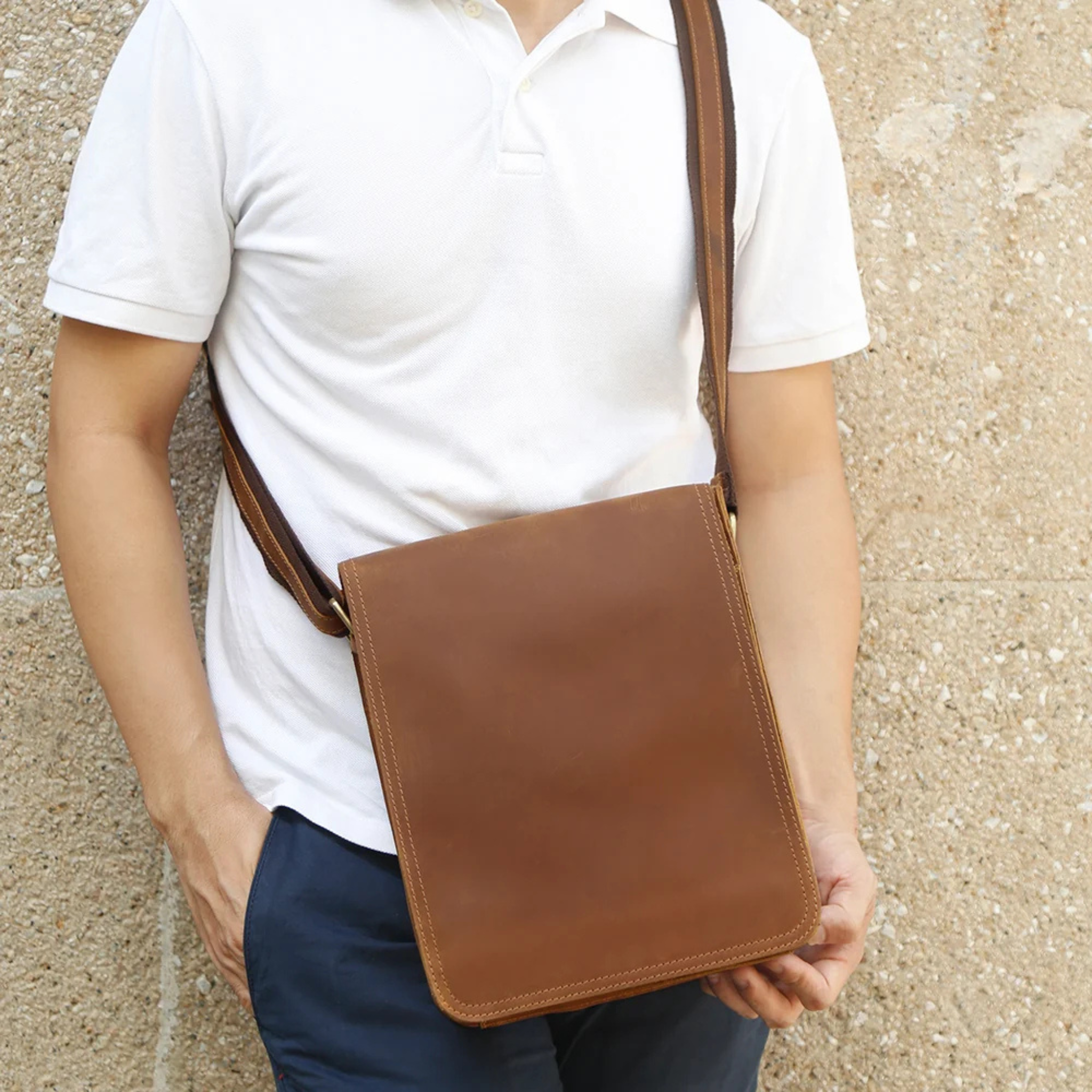Brown leather crossbody bag worn over the shoulder