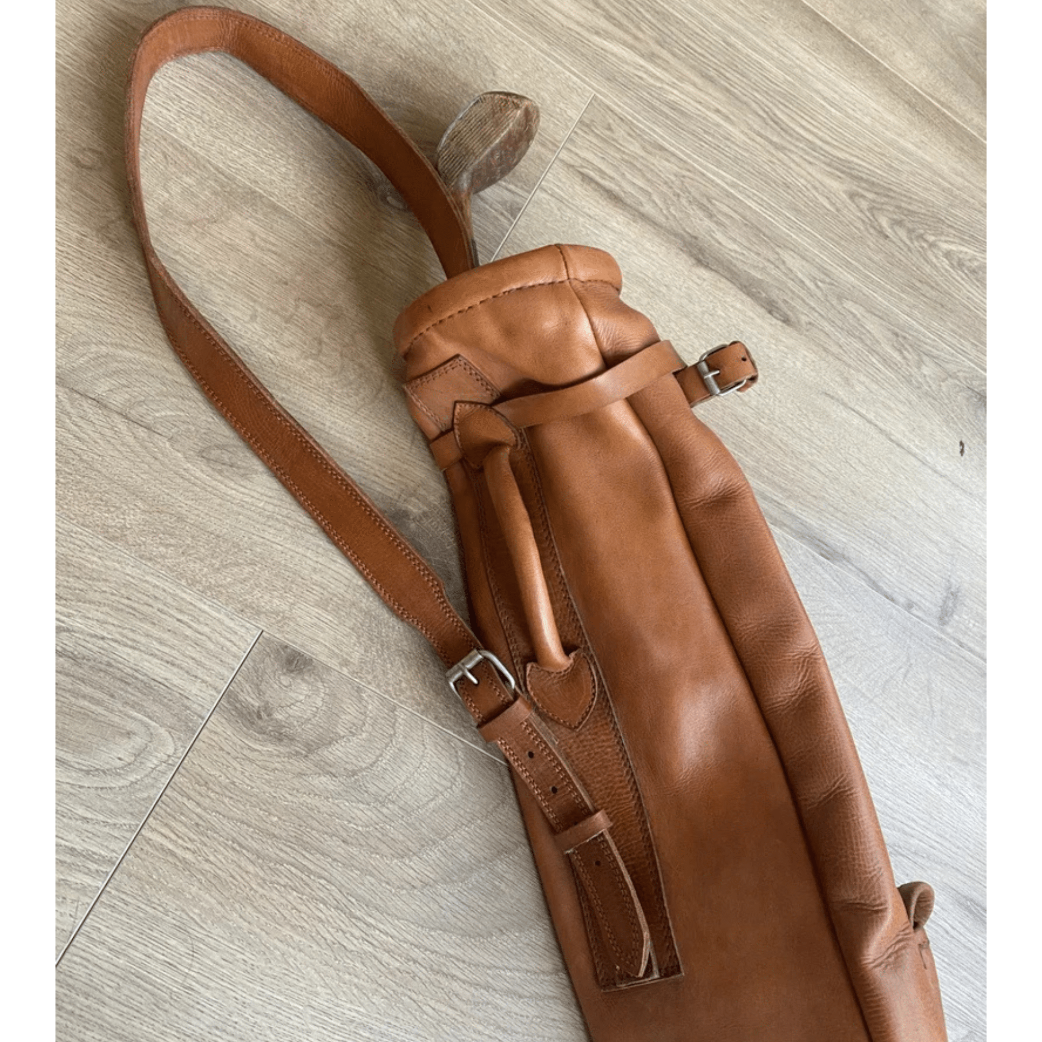 Side profile of handmade cowhide leather golf bag with shoulder strap