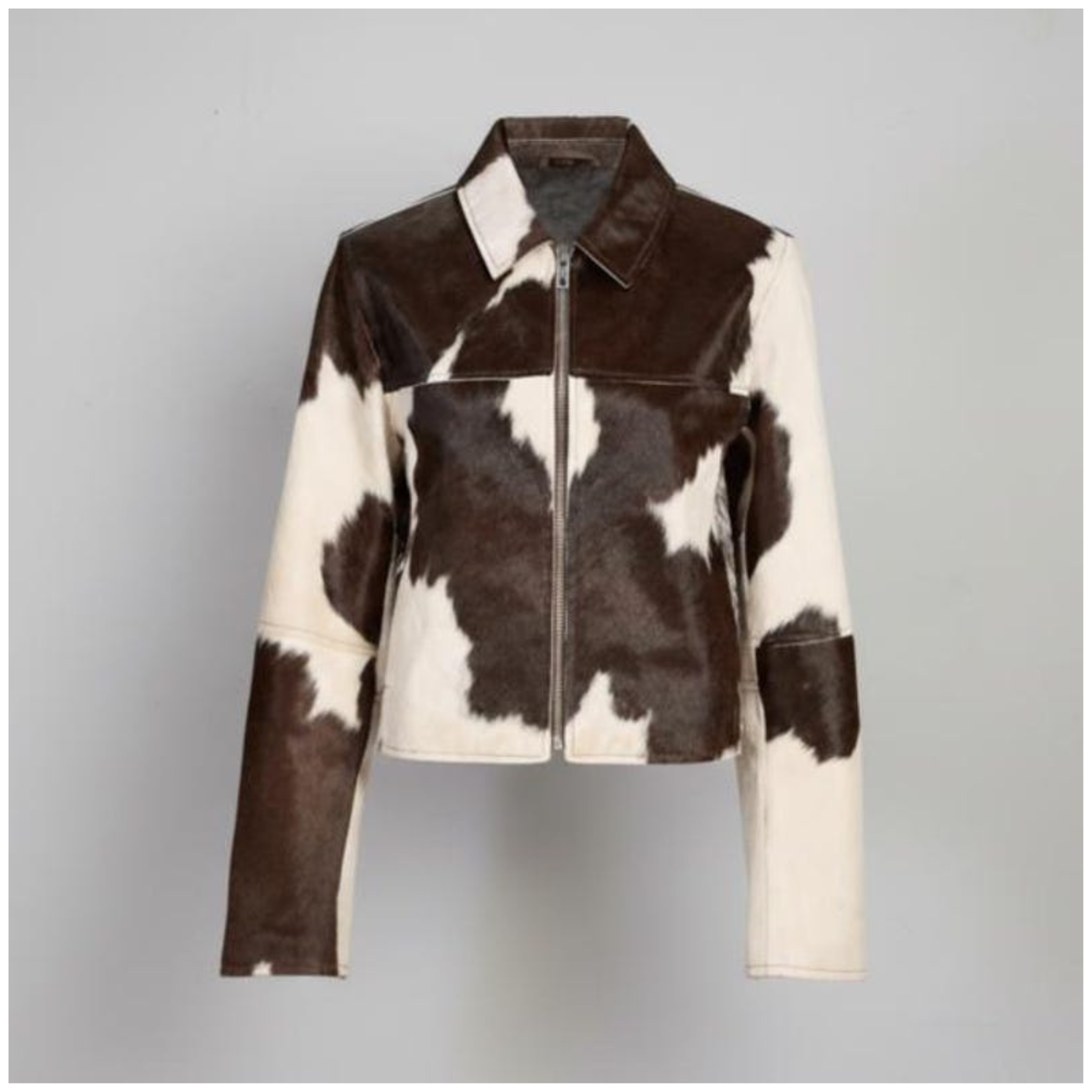 Front view of women brown & white cowhide leather jacket with zip-up design made from genuine leather